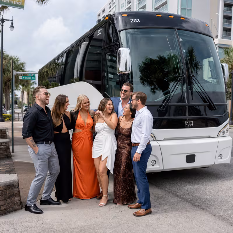 Passengers loading luggage while boarding an Myrtle Beach group shuttle