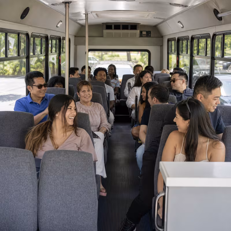 Group boarding a white charter bus for Private Event Transportation transportation in Myrtle Beach